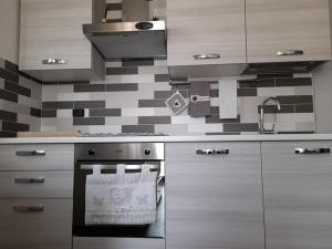 a kitchen with a stove and a sink at Dimora Palma in Alberobello