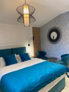a bedroom with a blue bed and a mirror at Kotor Lux apartments and rooms in Kotor