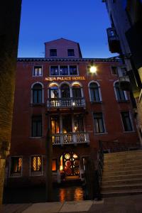 a tall red brick building with a sign on it at Aqua Palace in Venice