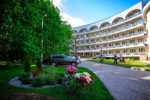 a large building with flowers in a park at Vozdvizhenskoe Park Hotel in Serpukhov