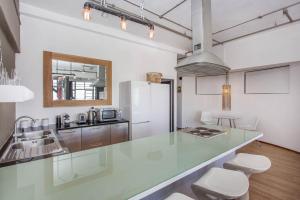 a kitchen with a counter top and a refrigerator at Manhattan Lofts in Cape Town