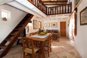 sala de estar con mesa de madera y escalera en Can Cremat, en Puerto Pollensa