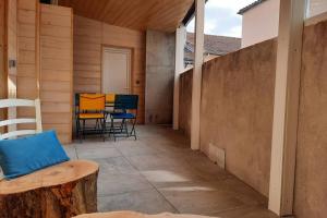 an outdoor patio with chairs and a table at Le liberté in Aubenas