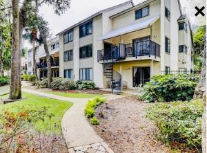 a large apartment building with a pathway in front of it at Springwood Villas with pool excess half a mile from beach in Hilton Head Island