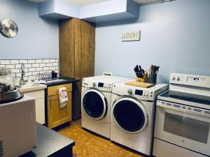 a kitchen with a washer and dryer and a sink at Journey's End - 2 bed 1 bath Suite in Golden