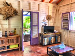 a room with a purple door and a table at Villa Deshaies in Deshaies
