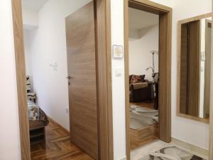 a hallway with a wooden door in a room at Enjoy Apartments Karamach in Ohrid