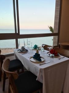 a dining table with a view of the ocean at Dakhla South Bay in Dakhla
