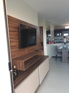 a living room with a flat screen tv on a wall at Apartamento Condomínio Sonhos da Serra - Bananeiras in Bananeiras