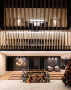 a lobby with a christmas tree and a large organ at VOTRE hotel in Jounieh