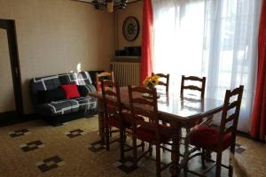 een woonkamer met een tafel en stoelen en een bank bij Gîte La Grappe - Proche Zoo Beauval in Châtillon-sur-Cher