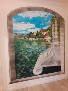 a mural on the wall of a room with a painting at Casa di Sofia e Oscar Lago di Como Canzo in Canzo