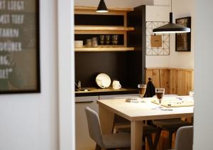 a kitchen with a table with two glasses of wine at Chalet Hans in Kurort Oberwiesenthal