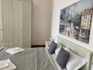 a bedroom with a bed and a painting on the wall at Al Fluviale in Ferrara