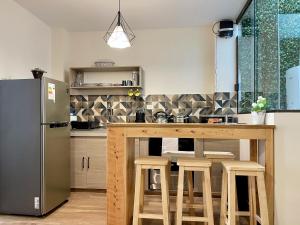 a kitchen with a wooden counter and a refrigerator at City Center 3-rooms apartment Downtown Sucre in Sucre