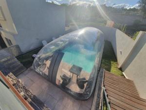 a pool in a plastic dome on top of a house at Apart Porto del Sol by CPH in Villa Carlos Paz +72 photos