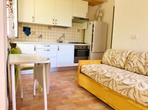 a kitchen with a couch and a table in a room at Borgo Castelluccio Country House in Porretta Terme