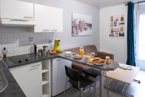 a kitchen with a table and a counter top at L'appart à Mimine in Chaudron-en-Mauges