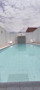 a large swimming pool with blue tiles on the floor at Casa con piscina privada in Girardot