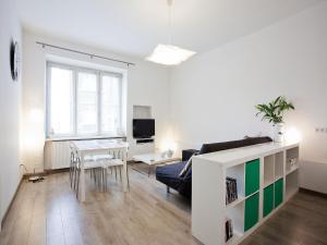 a living room with a couch and a table at Snow White Apartment in Krakow