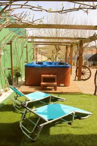 a deck with a hot tub and a bench and a table at Quinta Sobral Prestige - Little Rustic in Sobral de Monte Agraço