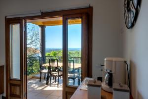 a kitchen with a door open to a balcony with a table at Sunny House in Loulé
