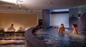 a group of people in a hot tub in a hotel at Virgilio Grand Hotel in Sperlonga