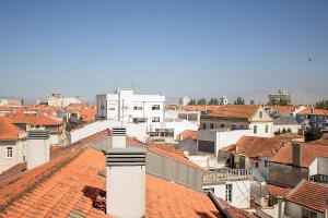 a view of a city with roofs and buildings at Aveiro Photo House - Bairro calmo no centro de Aveiro in Aveiro