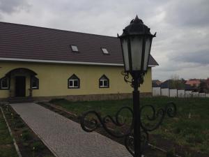 a street light in front of a yellow building at Formula Plus Motel in Lutsk