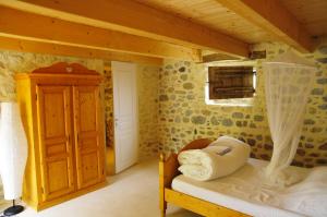 a bedroom with a bed in a wooden room at Gîtes du Domaine des Dames in Vallon-Pont-dʼArc