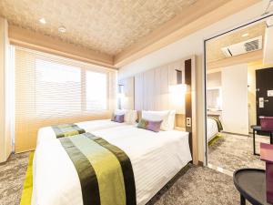 Hotel Musse Kyoto Shijo Kawaramachi Meitetsu客房内的一张或多张床位