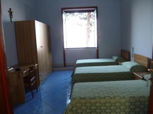 A bed or beds in a room at Ancelle Sorrento - Casa d'Accoglienza
