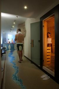 a man walking through a room with a map on the floor at Virgilio Grand Hotel in Sperlonga