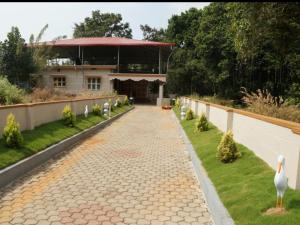 a walkway in front of a house with a building at Reunion Villa Abode in Udupi