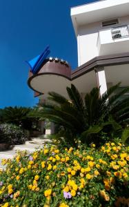 a building with a bunch of flowers in front of it at Virgilio Grand Hotel in Sperlonga