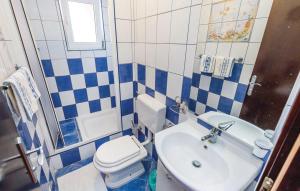 a blue and white bathroom with a toilet and a sink at Bed & Breakfast Valentina in Metajna +29 photos