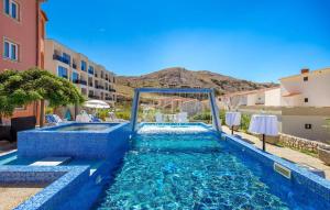 a swimming pool with blue water in a building at Bed & Breakfast Valentina in Metajna