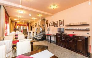 a restaurant with tables and chairs and a staircase at Bed & Breakfast Valentina in Metajna