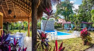 a patio with a table and chairs and a swimming pool at Bungalow Natura Village in Sosúa