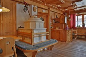 - une salle à manger avec une cuisinière dans une pièce en bois dans l'établissement Hotel Pörnbacher, à Valdaora