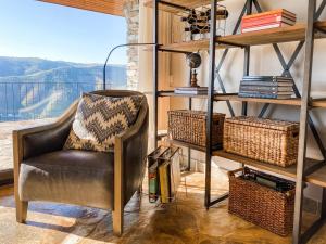 a chair in a room with a book shelf at Vineyard and Views Exquisite Luxury Douro Villa with Sun-Drenched Infinity Pool in Folgosa