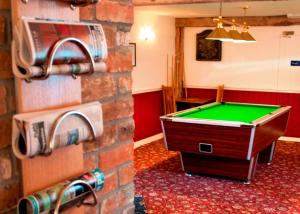 a room with a pool table on a brick wall at New Inn - Dorchester in Dorchester