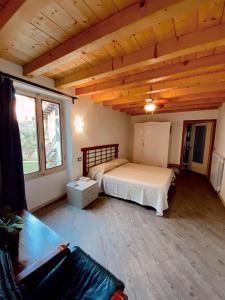 a bedroom with a bed in a room with wooden ceilings at Atlante in Toscolano Maderno