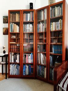 three book shelves filled with books in a room at Apartment History in Zagreb