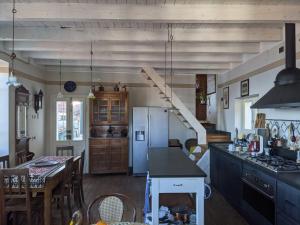 a kitchen with a refrigerator and a table in it at Ratto del Gallo in Stresa +11 photos