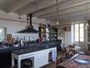a kitchen with a counter and a table with a dining room at Ratto del Gallo in Stresa