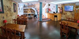 a restaurant with wooden tables and chairs and a bar at La Casona Canaria Boutique Home B & B in Agüimes