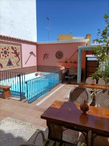 a patio with tables and chairs and a building at La Casona Canaria Boutique Home B & B in Agüimes