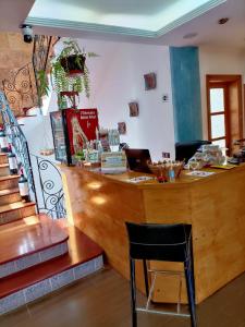 a bar in a restaurant with a table and a chair at La Casona Canaria Boutique Home B & B in Agüimes