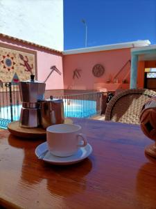 a cup of coffee on a table with a coffee maker at La Casona Canaria Boutique Home B & B in Agüimes
